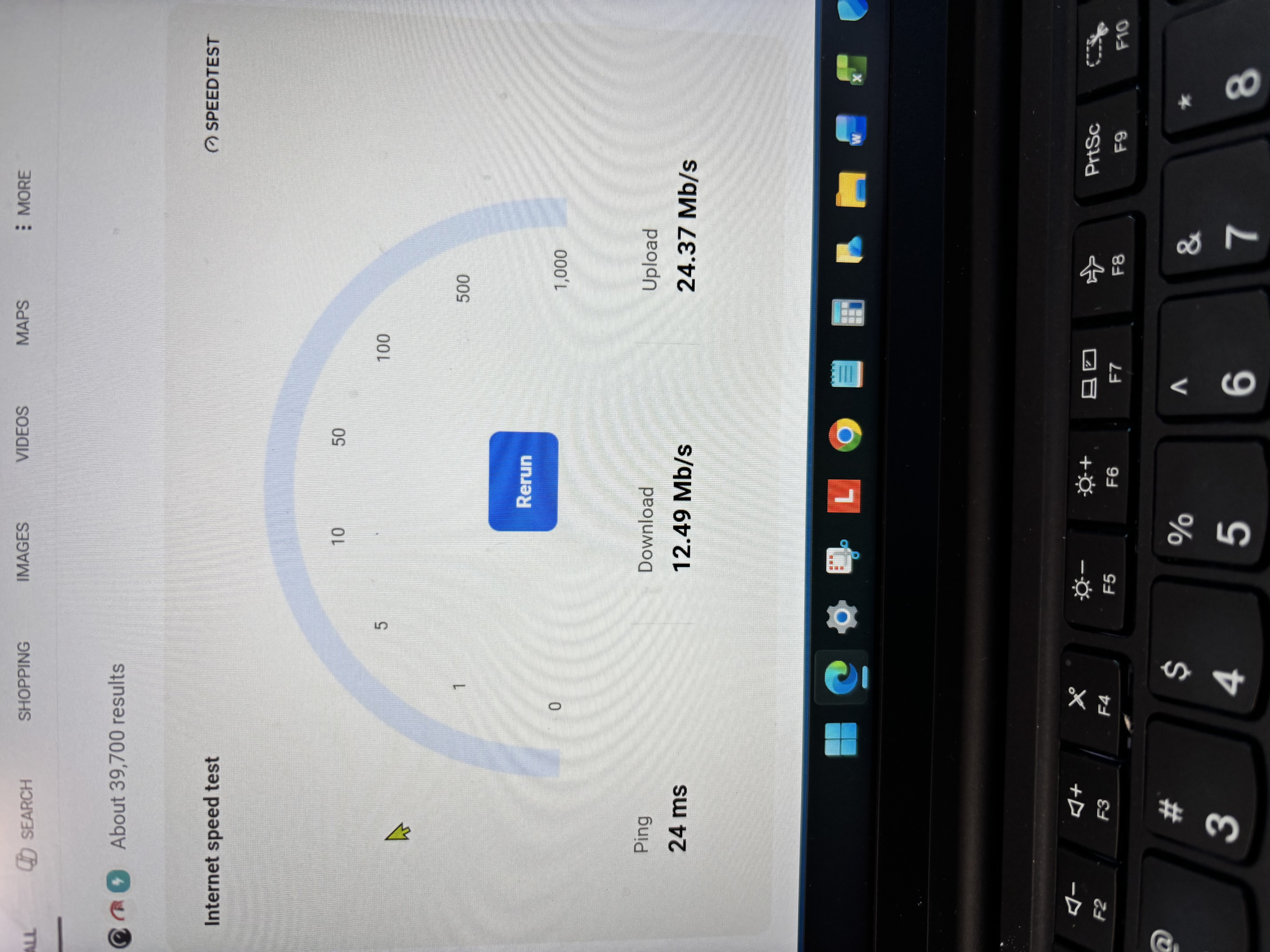Google internet speed test panel showing 12.49 Mbps download, 24.37 Mbps upload, and 24 ms ping on a laptop.