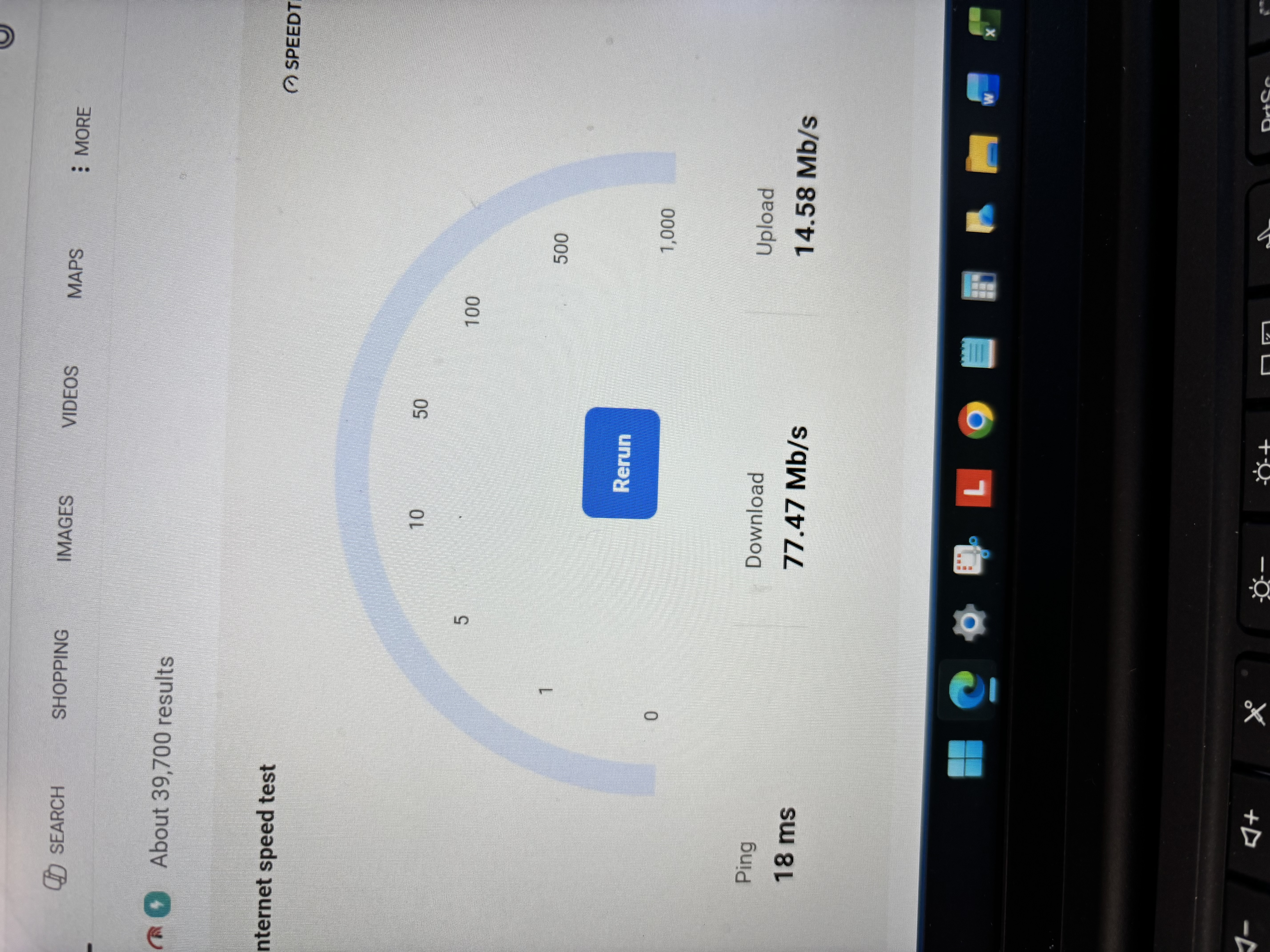 Google internet speed test panel showing 77.47 Mbps download, 14.58 Mbps upload, and 18 ms ping on a laptop.